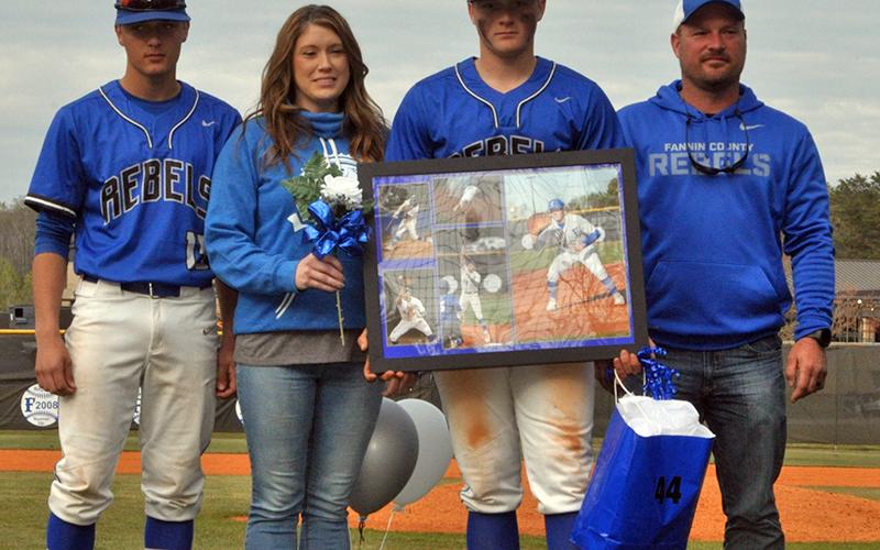 Bradley Holloway was one of seven Fannin County seniors honored in between games at the Rebels double header against Chattooga Friday, April 23. Shown are from left, Bryson Holloway, brother; Crystal Holloway, mother; Bradley Holloway, senior; and Joseph Holloway, father.
