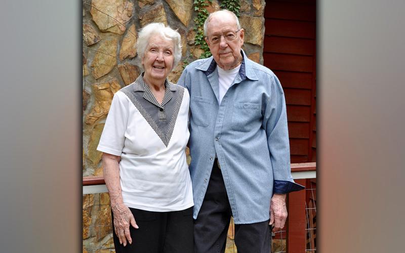 Mary and Peter Brown will celebrate 76 years of marriage April 20. They stand before the house they built together in Mineral Bluff.