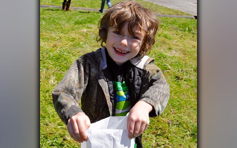 Kenneth Saye was all smiles after filling his bag with Easter eggs during the Fannin County High School Key Club hunt at West Fannin Elementary School.