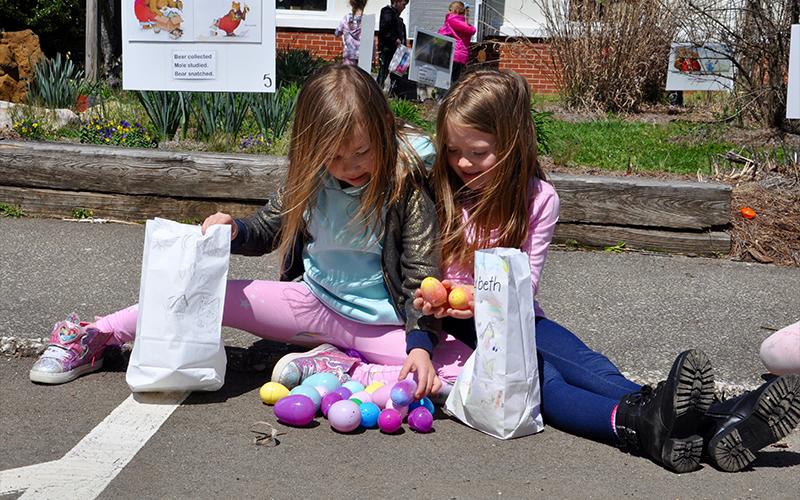 West Fannin Elementary School first grade students Cammie Lenz, left, and Elizabeth Alred compare colorful eggs during the Fannin County High School Key Club Easter egg hunt.