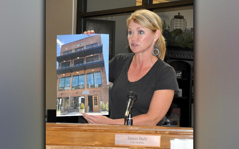 Councilwoman Rhonda Haight shows an image of a newer building that exceeds 35 feet in height during the Tuesday, March 30, town hall meeting.