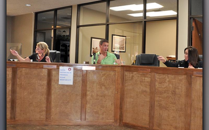 Councilman Nathan Fitts and Mayor Donna Whitener, right, argue with one another while Councilwoman Rhonda Haight engages in an exchange of words with Executive Parking Systems General Counsel Shelli Wojohn.