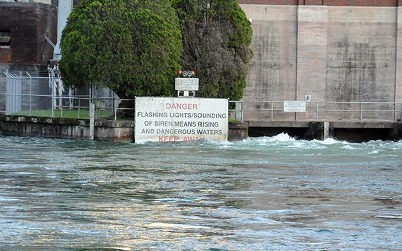 The effect of the amount of water being released through Blue Ridge Lake Dam by TVA is obvious as it rises above the bottom of the sign warning river users to be aware of rising and dangerous waters.