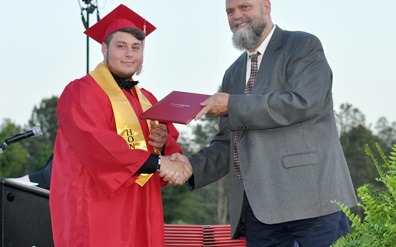 Joseph Johnson is all smiles as he receives his diploma from Polk County Director of Schools Dr. James Jones during Copper Basin’s graduation ceremony Thursday, May 20.