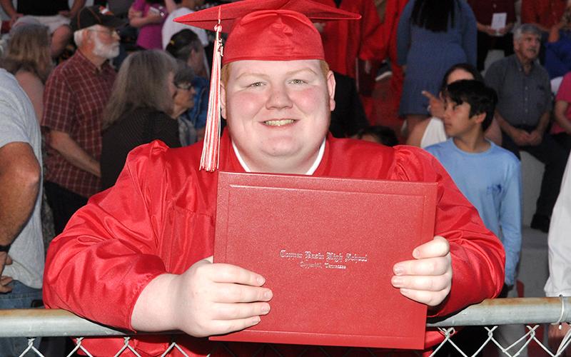 Class of 2021 graduate Ethan Carter shows off his hard-earned diploma after Copper Basin High School’s graduation ceremony Thursday, May 20. News Observer photos/Caleb Collins