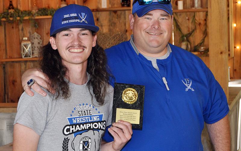 Kainan Henson was awarded the Three-Time Threat Award for placing in the state tournament three years. Henson placed fourth in the 2019 AAA State Tournament, sixth in the 2020 AAA State Tournament, and third in the 2021 AA State Tournament. Henson is shown with Head Coach Chuck Patterson