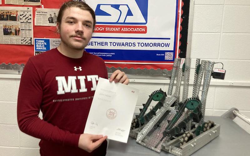 Fannin County High School senior John Moler is shown with his acceptance letter from the Massachusetts Institute of Technology (MIT) and a robot he and Luke Pelfrey engineered.
