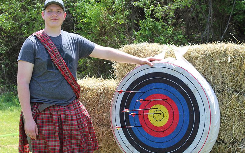 Troop 32 Boy Scout Ethan Jolly shows off his bulls-eye shot after he tackled the archery portion of Troop 32's Highland Games Saturday, May 1.