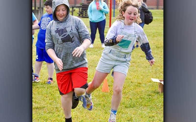 West Fannin Elementary School third-grade students Luke Sosebee and Ella Lackey compete in the three-legged race during field day Thursday, May 13.