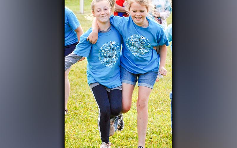 Fifth-grade students Ayla Walton, left, and Addyson Plott compete against their peers during West Fannin Elementary School’s field day Thursday, May 13.
