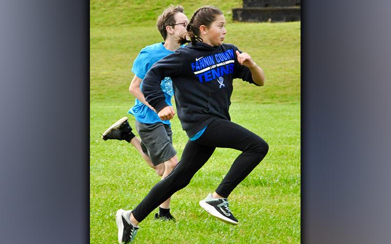 Sadie Patton pushes past Will O’Neal and into first place during a race against peers amidst West Fannin Elementary School’s field day.