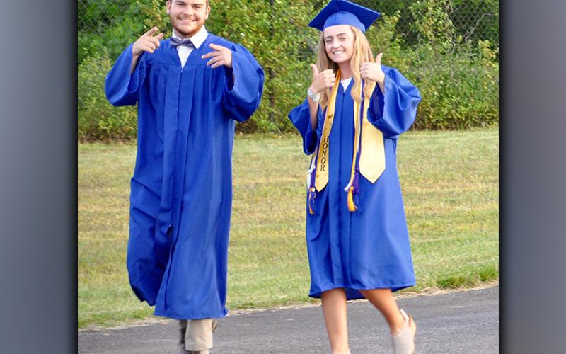 Fannin County High School graduates Maximus Mathis and Lainey Panter make their walk down to the football field before beginning the graduation ceremony Friday, May 21.