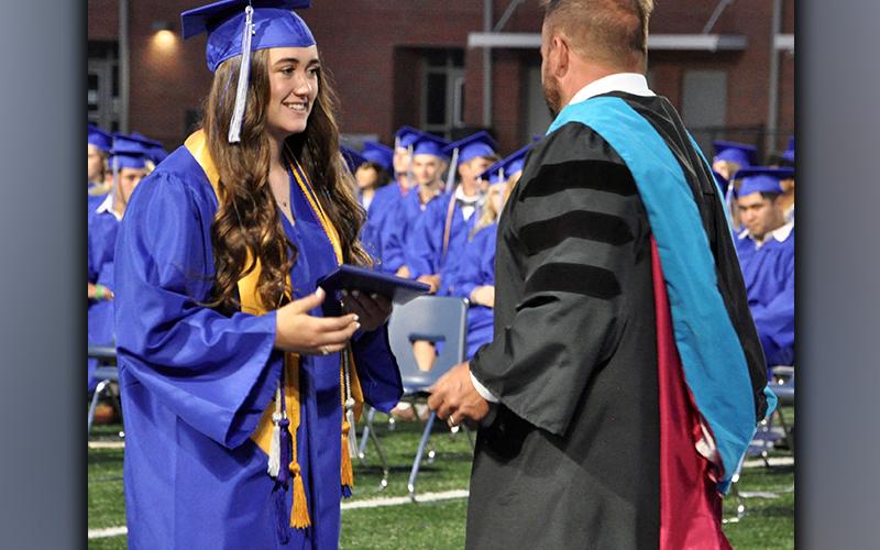 Catherine Ballew accepts her diploma from Fannin County High School 2021-22 Principal Dr. Scott Ramsey during graduation Friday, May 21.