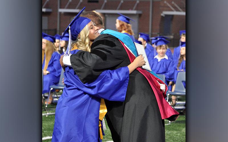 Teagan Cioffi embraces Fannin County High School 2021-22 Principal Dr. Scott Ramsey after being handed her diploma during graduation Friday, May 21.