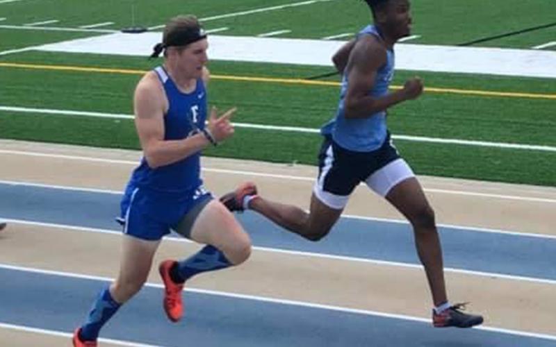 Thomas Mercer, left, battles with Aaron McFadden in the 300 Meter Hurdles Finals during the Track and Field Championships Saturday, May 15.