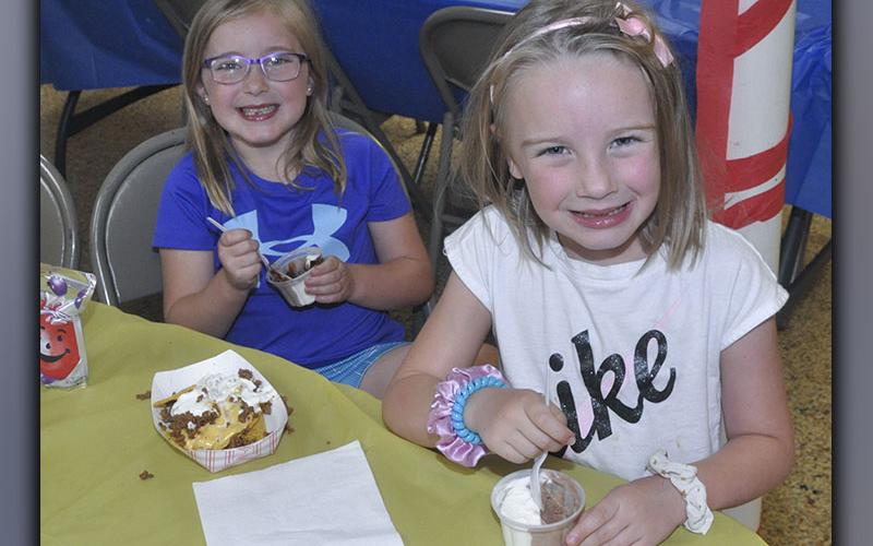 Maggie Nazerian, left and Millie Nazerian enjoy a meal at Vacation Bible School hosted by Pleasant Hill Baptist Church Wednesday, June 9.