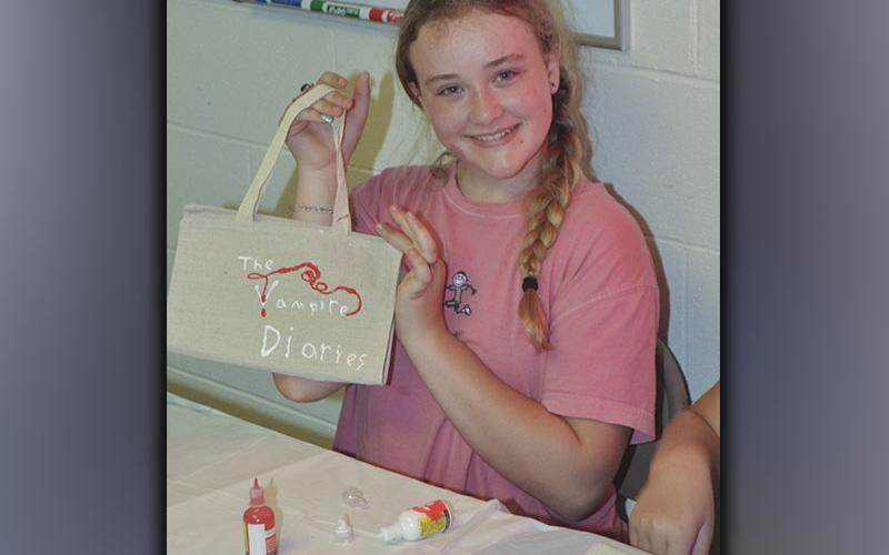 Jaelyn Breaux shows off her work during Pleasant Hill Baptist Church’s Vacation Bible School Wednesday, June 9.