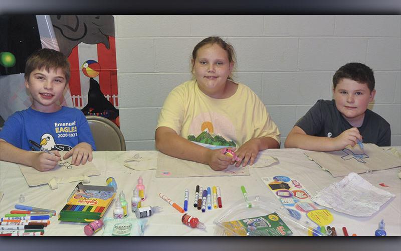 Kids created Bible covers in arts and crafts at Pleasant Hill Baptist Church’s Vacation Bible School Wednesday, June 9. Shown working on their crafts are, from left, Georgee Bonilla, Lacey Long and TJ Hughes.