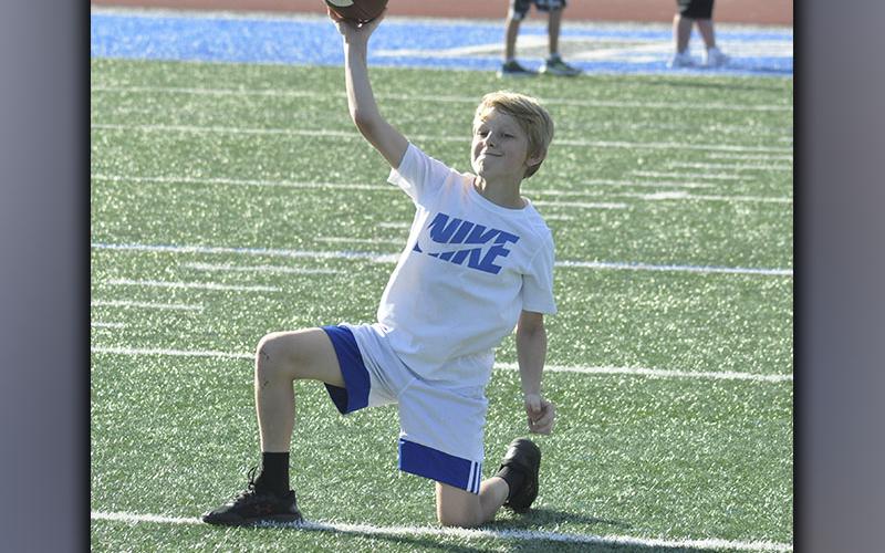 Bentlee Jackson works with the quarterback group on his throwing technique during the Fannin County High School football youth camp Wednesday, June 16.