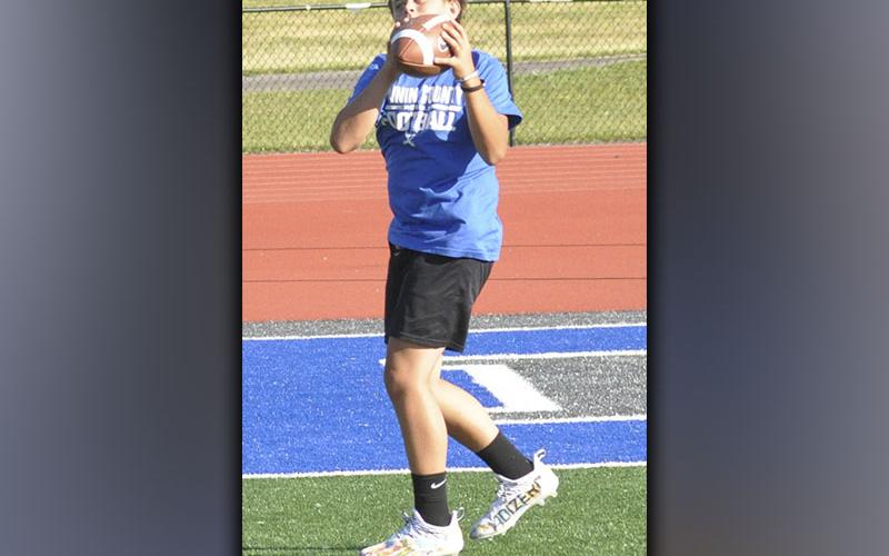 Reid Holloway works on his focus while he catches a pass during football camp hosted by the Fannin County High School football staff Wednesday, June 16.