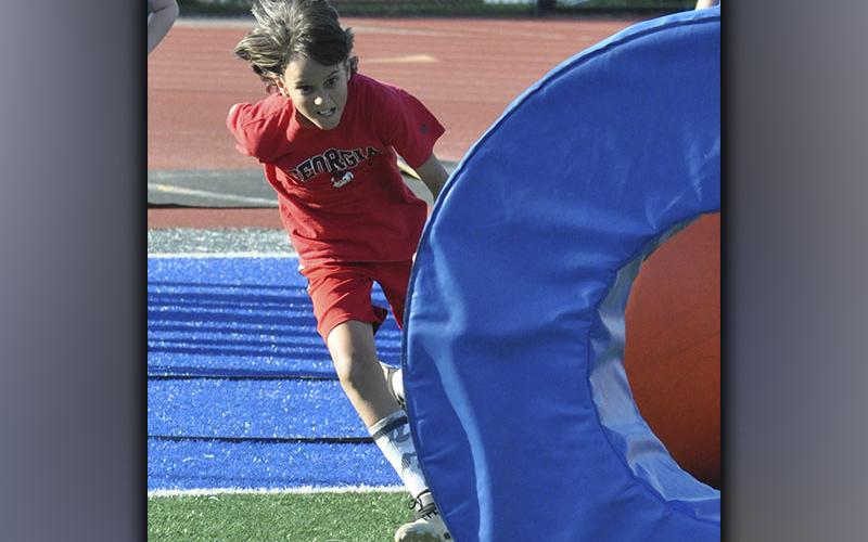 Evander Patterson gets low during a tackling drill at the Fannin County High School football camp Wednesday, June 16.
