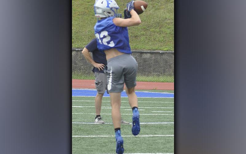 Easton Chancey snags a pass for a gain during the Rebels’ football scrimmage Wednesday, June 9.