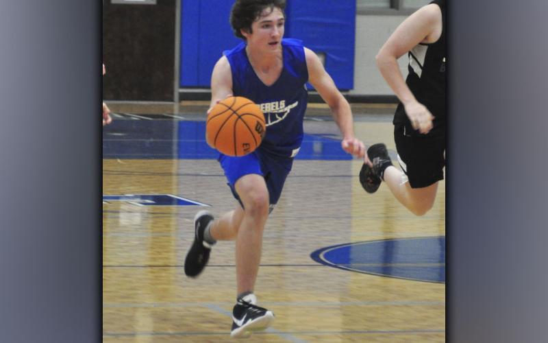 Will Jones pushes the ball up the floor in the Rebels basketball scrimmage with Gilmer County Wednesday, June 16.