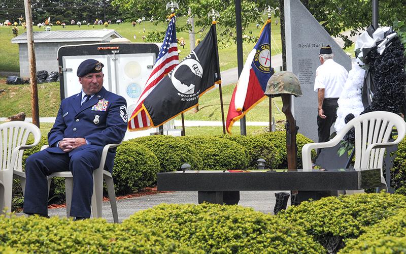 Retired Senior Master Sergeant Harold Bargeron takes a moment to reflect after the placing of the helmet, rifle and boots at the Memorial Day service.