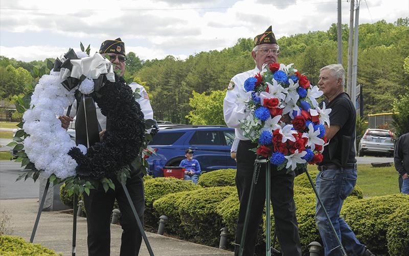 Richard Crosley (left) and Ron Wallace placed wreaths during the Memorial Day ceremony Monday at Veterans Memorial Park.