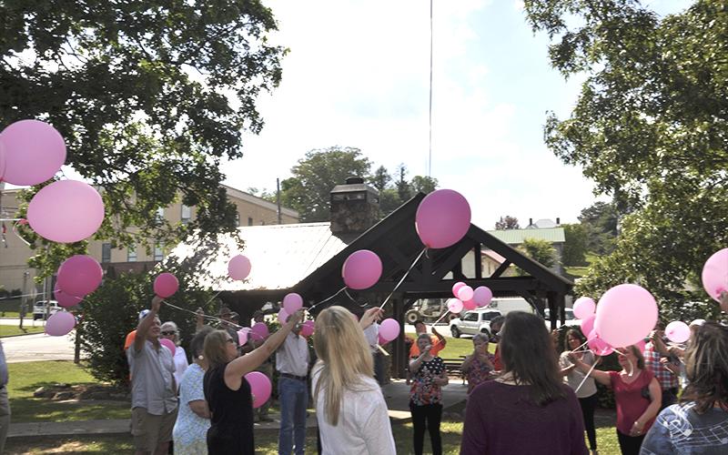 Pink balloons fill the air during a Celebration of Life ceremony in honor of Glenda Herndon in the downtown Blue Ridge park Wednesday, May 26. Herndon passed away May 19 and had worked for the City of Blue Ridge for several years.