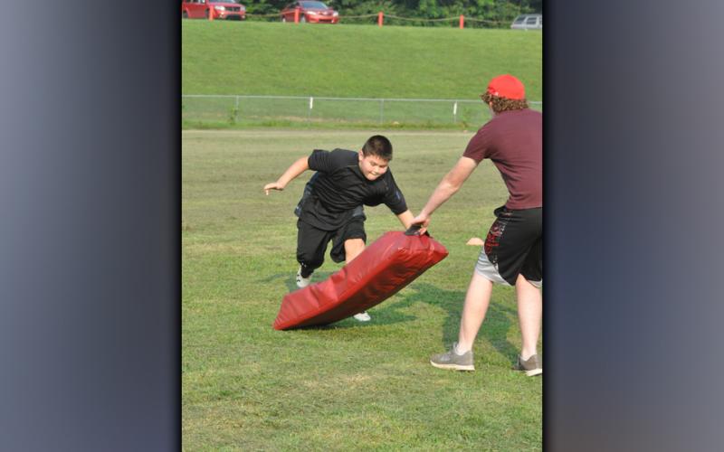 Trenton Davis works on his tackling technique during the youth football camp hosted by the Copper Basin High School football team Thursday, July 22.