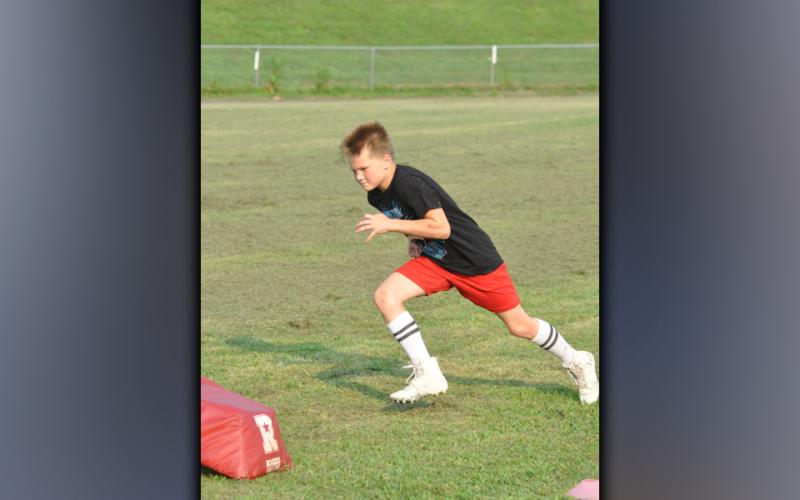 Christopher Kraft works on his leverage during the Copper Basin High School football team’s youth football camp Thursday, July 22.