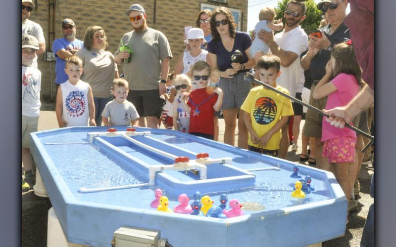 Kids and parents gather around the water race track during one of the rubber duck races at the Miner’s Homecoming in Ducktown Saturday, June 26.