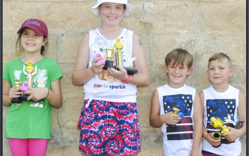 The Great American Duck Race took the winners of the three heats and then raced for the first place trophy. The winners of the Great American Duck Race are, from left, Kariyana Donev, first place; Taber Pass, second place; Kaison Boring, fourth place; and Owen Mull, third place.