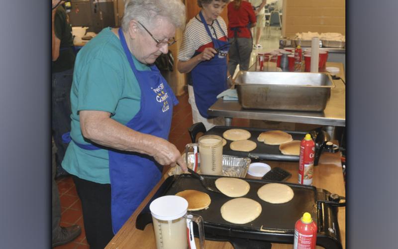 Dee Magero gets the pancakes golden brown during the Epworth Community Club’s Pancake Breakfast Saturday, July 3.