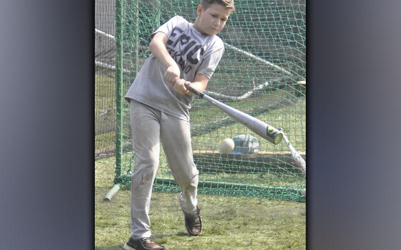 Liam Highley dings a ball during the hitting camp hosted by the Fannin County High School baseball coaches and players Wednesday, July 14.