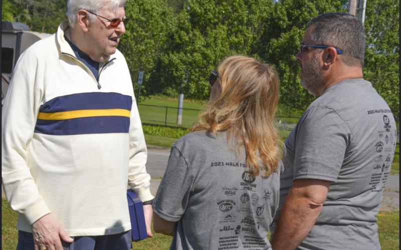 Saint Anthony’s Catholic Church Deacon Loris Sinanian talks with two individuals participating in HER HOPE Pregnancy Center’s Walk for Life fundraiser Saturday, June 26.