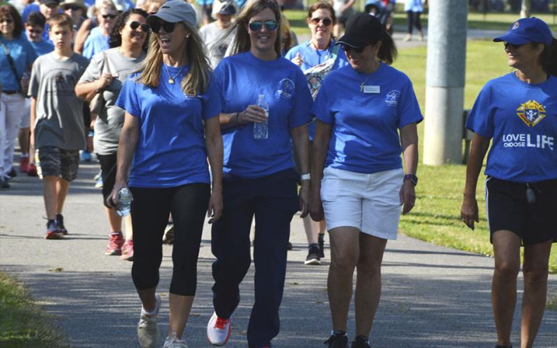Individuals participate during HER HOPE Pregnancy Center’s Walk for Life fundraiser Saturday, June 26.