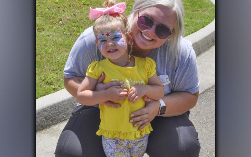 Raelynn King shows off her face painting with her aunt Gracie Rogers during the festivities at Blue Ridge Assisted Living and Memory Care Friday, July 2.