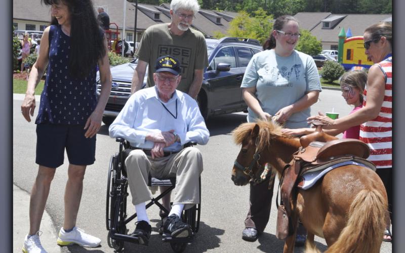 Among those enjoying the festivities at Blue Ridge Assisted Living and Memory Care Friday, July 2, are, clockwise, from left, Judy Overvoid and Chris Overvoid with Judy’s father, U.S. Air Force veteran John Turgeon.