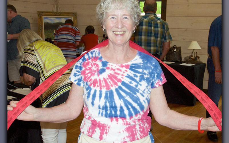 Suzanne Stedman walks around during Paws for Celebration selling 50/50 raffle tickets Saturday, July 17.