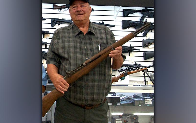 Disabled American Veterans (DAV) Commander Paul Hunter shows off the M1 Garand rifle the chapter is raffling to raise money. A .45 caliber Rock Island pistol is also being raffled. The DAV purchased both guns from McCaysville Drug &amp; Gun. Chances to win the guns can be purchased at the veterans cookout Thursday.