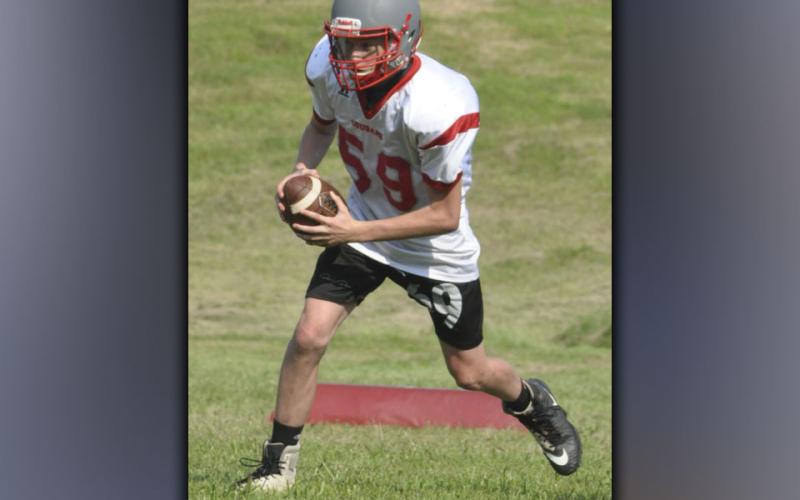 Quarterback Isaac Deal rolls out and surveys his options during the Copper Basin High School football practice Wednesday, July 28.