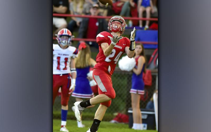 Cadan Williams hauls in a catch for a big gain during the Cougars game against the Polk County Wildcats Friday, August 20.