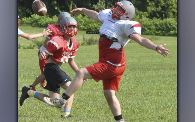 Cade Foster swats down a pass during a scrimmage at the Copper Basin Cougars’ football practice Wednesday, July 28.