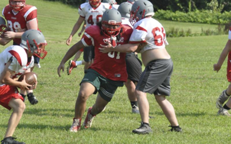 Krus Soto, left, tries to break away from Garrett Hedden during the Copper Basin Cougars football practice Wednesday, July 28.