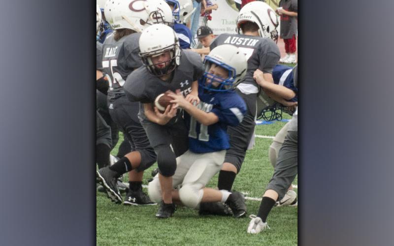 Job Conklin bust through the line of scrimmage for a big sack during the Fannin County recreation center’s football jamboree Saturday, August 21.