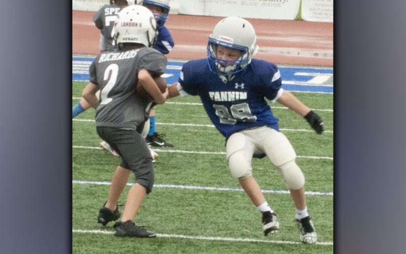 Brock Satterfield (88) makes a defensive play for the Rebels during the football jamboree Saturday, August 21.