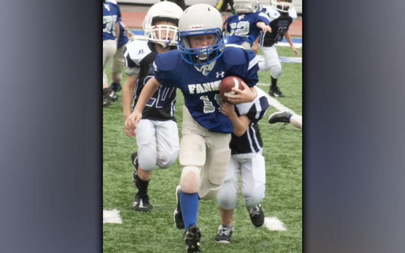 Colt Kinser (10) muscles past defenders during the Rebels jamboree Saturday, August 21.