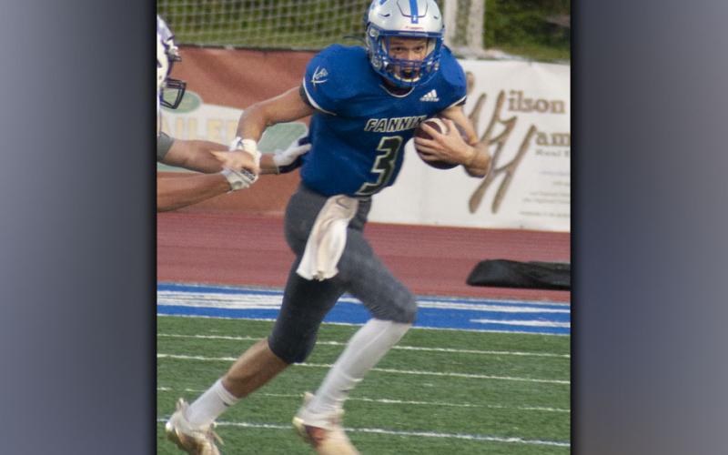 Quarterback David Mashburn (3) avoids a Union County defender and takes off for a nice run during the Rebels game against the Panthers Friday, August 20.